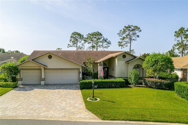 8132 Summersong Ct, Spring Hill, FL 34606 - single story home featuring stucco siding, a garage, decorative driveway, and a front lawn