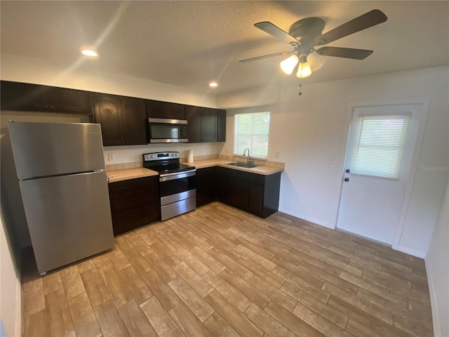 11392 Beechdale Ave, Spring Hill, FL 34608 - kitchen featuring stainless steel appliances, a sink, light countertops, light wood finished floors, and recessed lighting