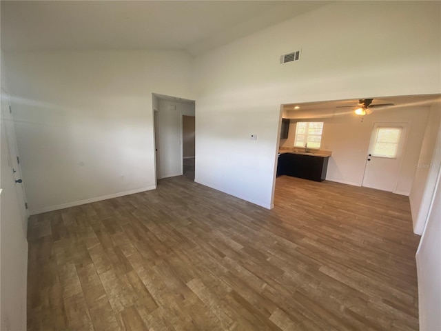 11392 Beechdale Ave, Spring Hill, FL 34608 - unfurnished room with dark wood-type flooring, a ceiling fan, high vaulted ceiling, and baseboards