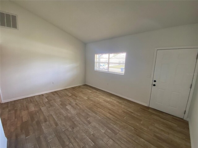 11392 Beechdale Ave, Spring Hill, FL 34608 - spare room with lofted ceiling, wood finished floors, and baseboards