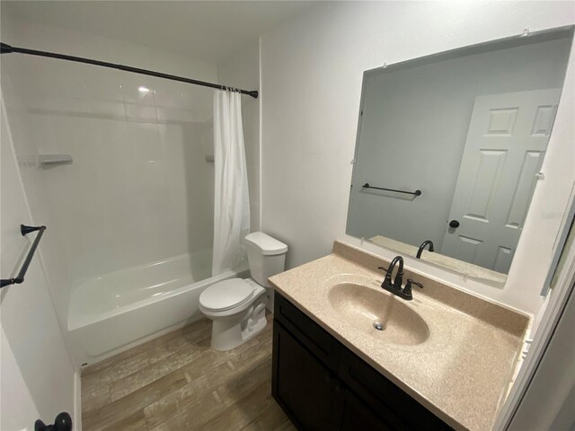 11392 Beechdale Ave, Spring Hill, FL 34608 - bathroom with wood finished floors, vanity, shower / bath combo with shower curtain, and toilet