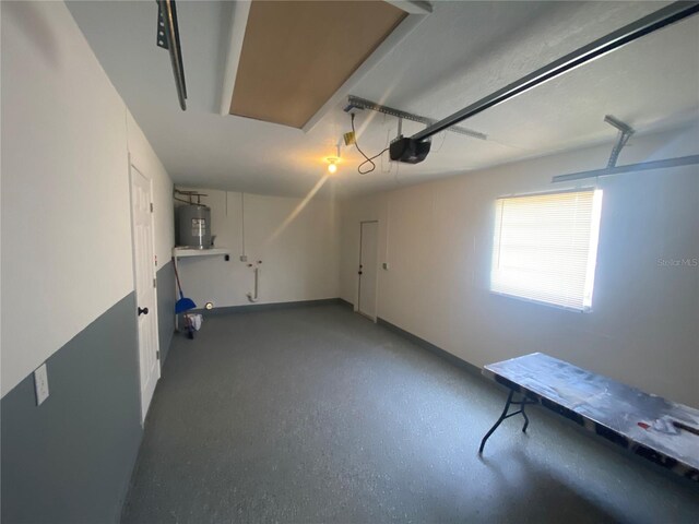 11392 Beechdale Ave, Spring Hill, FL 34608 - garage featuring electric water heater, a garage door opener, and baseboards
