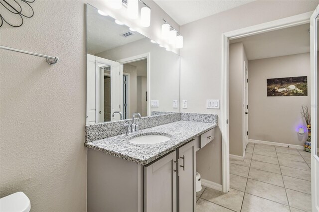 3886 Reflection Dock Dr, Seffner, FL 33584 - bathroom with toilet, tile patterned floors, vanity, and baseboards
