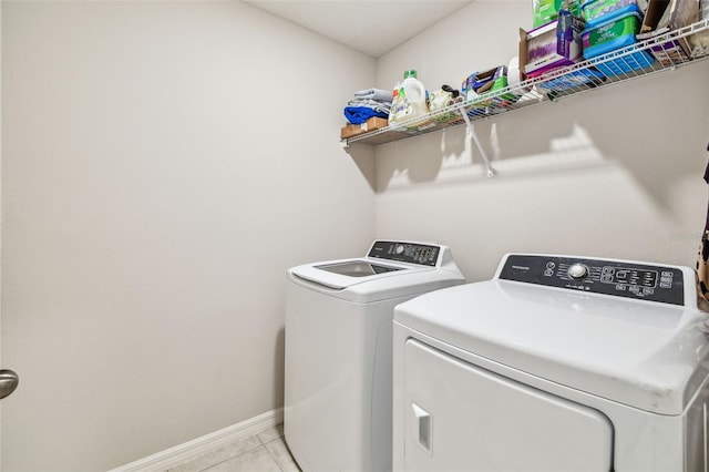 3886 Reflection Dock Dr, Seffner, FL 33584 - laundry room featuring washer and dryer, light tile patterned floors, and baseboards