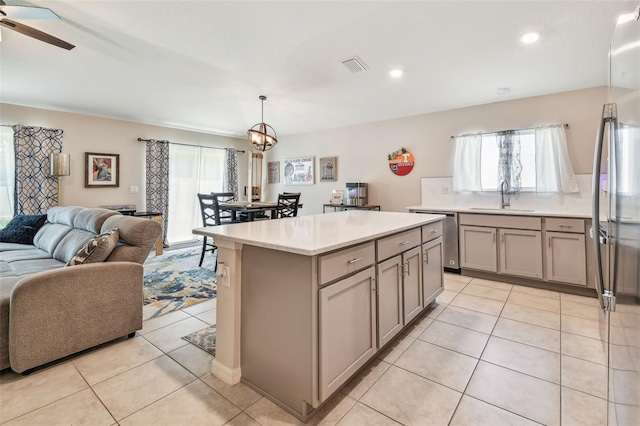 3886 Reflection Dock Dr, Seffner, FL 33584 - kitchen with open floor plan, a sink, gray cabinets, stainless steel dishwasher, and light tile patterned floors