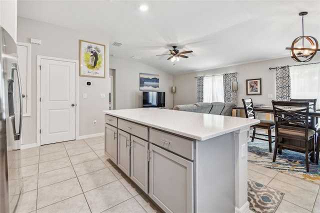 3886 Reflection Dock Dr, Seffner, FL 33584 - kitchen with gray cabinetry, a ceiling fan, light tile patterned floors, a center island, and a chandelier