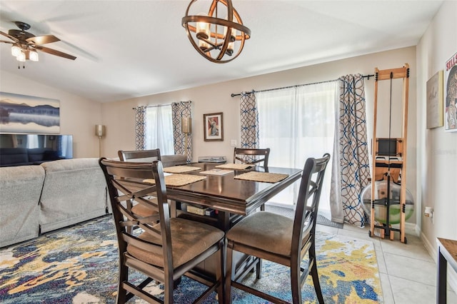 3886 Reflection Dock Dr, Seffner, FL 33584 - dining area featuring a chandelier, ceiling fan, light tile patterned floors, vaulted ceiling, and baseboards