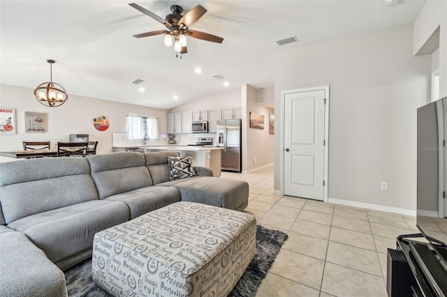 3886 Reflection Dock Dr, Seffner, FL 33584 - living area featuring a ceiling fan, vaulted ceiling, light tile patterned floors, a chandelier, and baseboards