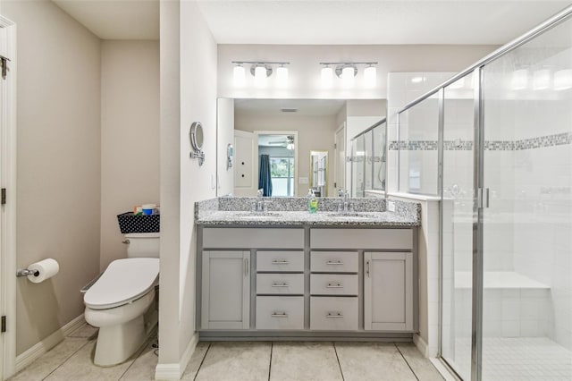 3886 Reflection Dock Dr, Seffner, FL 33584 - bathroom featuring toilet, double vanity, a stall shower, tile patterned flooring, and baseboards