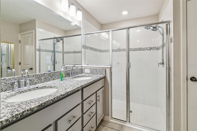 3886 Reflection Dock Dr, Seffner, FL 33584 - bathroom featuring a stall shower, double vanity, tile patterned flooring, and recessed lighting
