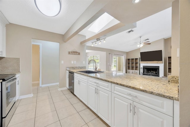 11291 Countrywood Ct, Spring Hill, FL 34609 - kitchen with appliances with stainless steel finishes, a sink, a skylight, a fireplace, and ceiling fan