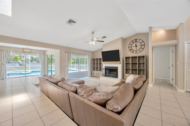 11291 Countrywood Ct, Spring Hill, FL 34609 - living area with light tile patterned floors, a fireplace, vaulted ceiling, ceiling fan, and baseboards