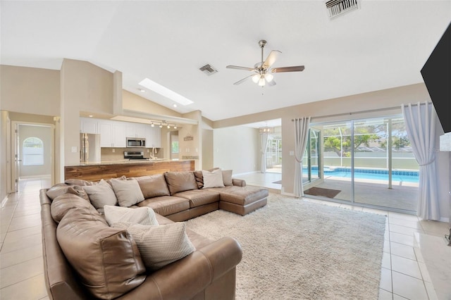 11291 Countrywood Ct, Spring Hill, FL 34609 - living area featuring ceiling fan, light tile patterned floors, baseboards, plenty of natural light, and high vaulted ceiling