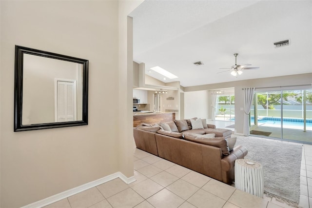 11291 Countrywood Ct, Spring Hill, FL 34609 - living room featuring vaulted ceiling, baseboards, a ceiling fan, and light tile patterned floors