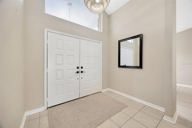 11291 Countrywood Ct, Spring Hill, FL 34609 - entryway featuring a towering ceiling, light tile patterned flooring, and baseboards