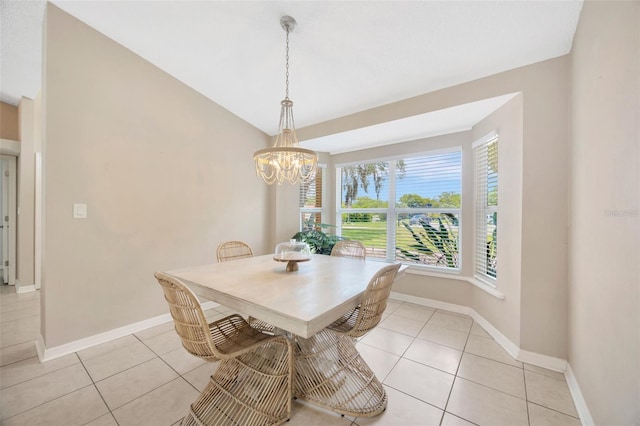 11291 Countrywood Ct, Spring Hill, FL 34609 - dining space featuring a chandelier, baseboards, light tile patterned flooring, and lofted ceiling