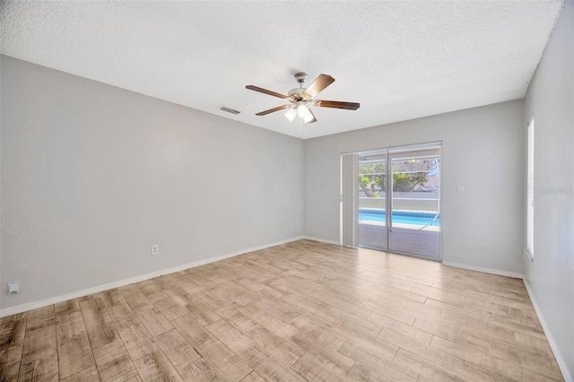 11291 Countrywood Ct, Spring Hill, FL 34609 - spare room with a ceiling fan, wood finished floors, a textured ceiling, and baseboards