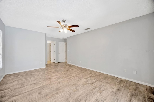 11291 Countrywood Ct, Spring Hill, FL 34609 - empty room with a ceiling fan, light wood-style flooring, and baseboards