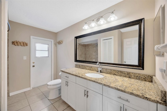 11291 Countrywood Ct, Spring Hill, FL 34609 - full bath featuring vanity, toilet, tile patterned floors, baseboards, and a textured ceiling