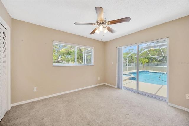 11291 Countrywood Ct, Spring Hill, FL 34609 - unfurnished bedroom featuring carpet, multiple windows, access to exterior, and baseboards