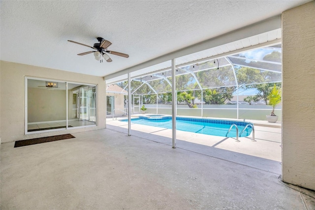 11291 Countrywood Ct, Spring Hill, FL 34609 - view of swimming pool with a ceiling fan, a patio, a pool with connected hot tub, and glass enclosure