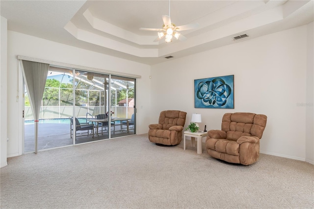 5423 Abagail Dr, Spring Hill, FL 34608 - sitting room featuring ceiling fan, carpet, a raised ceiling, and a sunroom
