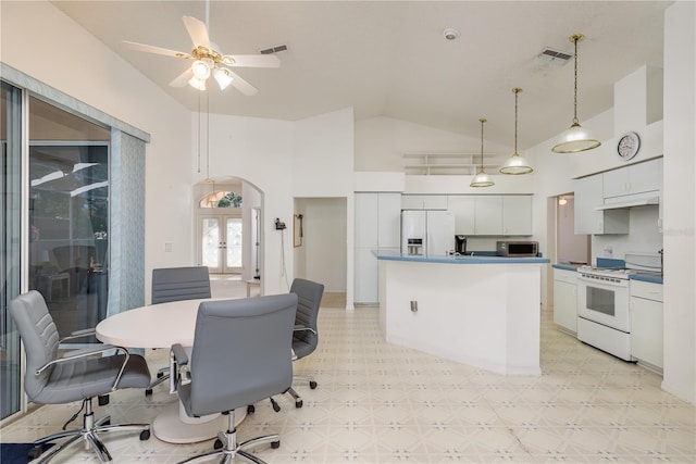 5423 Abagail Dr, Spring Hill, FL 34608 - dining space with light floors, arched walkways, french doors, ceiling fan, and high vaulted ceiling