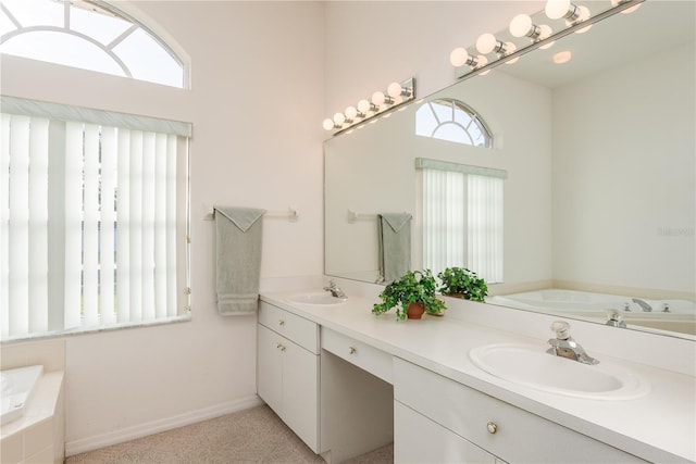 5423 Abagail Dr, Spring Hill, FL 34608 - bathroom with plenty of natural light, double vanity, and a garden tub