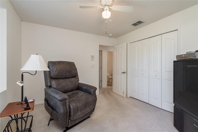 5423 Abagail Dr, Spring Hill, FL 34608 - living area with light colored carpet, a ceiling fan, and a textured ceiling