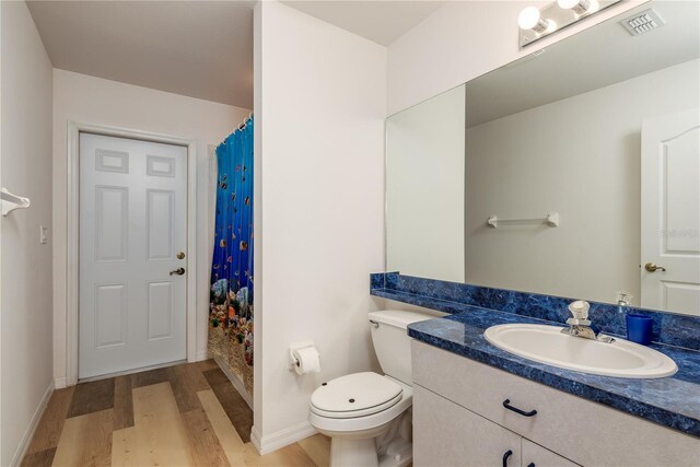 5423 Abagail Dr, Spring Hill, FL 34608 - full bathroom with wood finished floors, vanity, and a shower with curtain