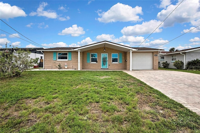 12637 2nd Isle, Hudson, FL 34667 - ranch-style home with an attached garage, decorative driveway, a front yard, and brick siding