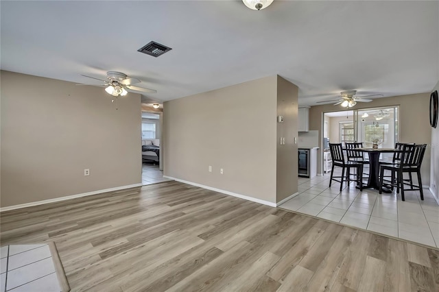 12637 2nd Isle, Hudson, FL 34667 - dining room featuring ceiling fan, light wood-style flooring, plenty of natural light, and baseboards