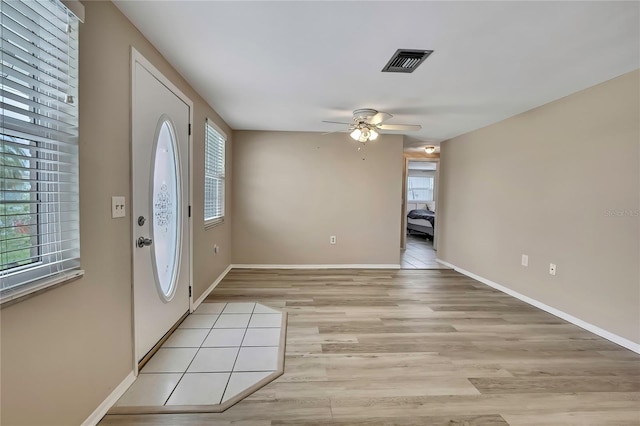 12637 2nd Isle, Hudson, FL 34667 - foyer featuring a ceiling fan, baseboards, and light wood-type flooring