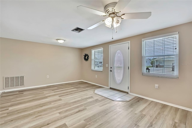 12637 2nd Isle, Hudson, FL 34667 - entrance foyer with light wood finished floors, ceiling fan, and baseboards