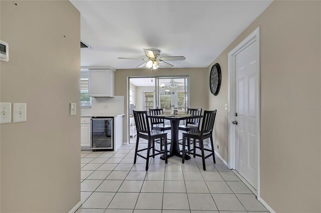 12637 2nd Isle, Hudson, FL 34667 - dining room featuring beverage cooler, ceiling fan, plenty of natural light, and light tile patterned flooring