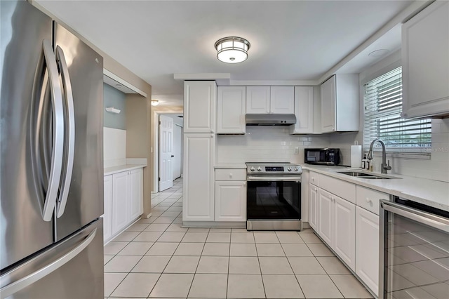 12637 2nd Isle, Hudson, FL 34667 - kitchen with stainless steel appliances, wine cooler, a sink, under cabinet range hood, and light tile patterned flooring