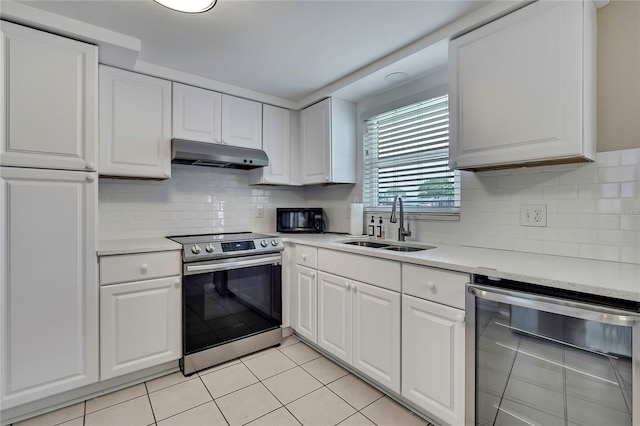 12637 2nd Isle, Hudson, FL 34667 - kitchen with beverage cooler, stainless steel electric range oven, under cabinet range hood, a sink, and light tile patterned floors