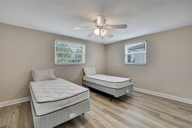 12637 2nd Isle, Hudson, FL 34667 - bedroom with wood finished floors, baseboards, and ceiling fan