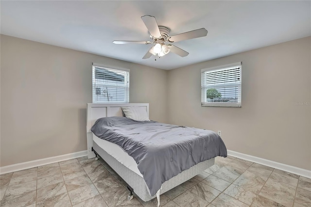 12637 2nd Isle, Hudson, FL 34667 - bedroom with multiple windows, baseboards, and a ceiling fan