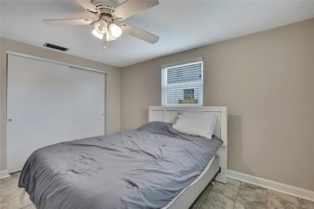 12637 2nd Isle, Hudson, FL 34667 - bedroom featuring baseboards, ceiling fan, and a closet