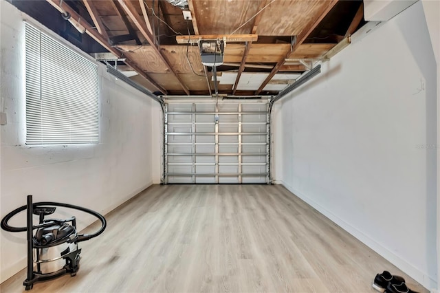 12637 2nd Isle, Hudson, FL 34667 - garage featuring baseboards and a garage door opener
