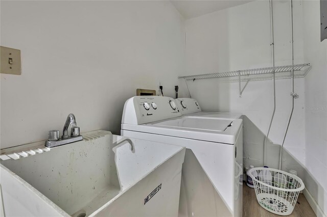 12637 2nd Isle, Hudson, FL 34667 - washroom featuring washing machine and clothes dryer and wood finished floors