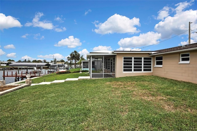 12637 2nd Isle, Hudson, FL 34667 - view of green lawn with a sunroom, a boat dock, and boat lift