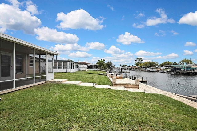 12637 2nd Isle, Hudson, FL 34667 - view of grassy yard featuring a sunroom, a water view, and a dock
