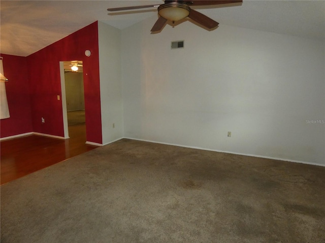 7421 Fairfax Dr, Port Richey, FL 34668 - unfurnished room with vaulted ceiling, carpet, ceiling fan, and baseboards