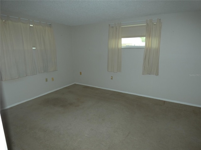 7421 Fairfax Dr, Port Richey, FL 34668 - unfurnished room with carpet floors, a textured ceiling, and baseboards