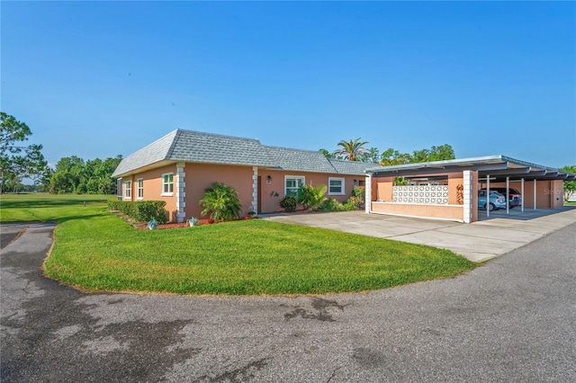 9622 Brassie Ct Unit 9, New Port Richey, FL 34655 - view of front of property featuring a front yard, stucco siding, and mansard roof