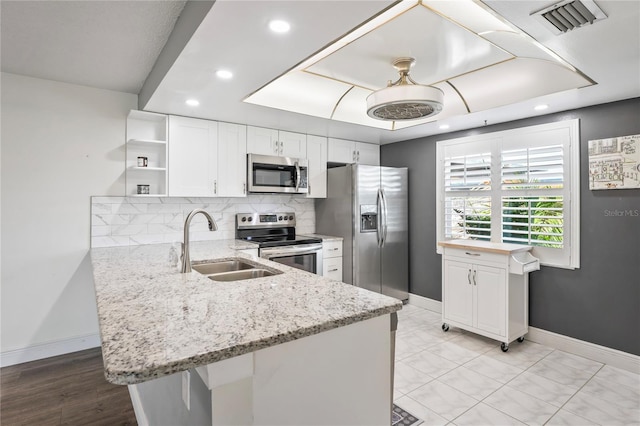 9622 Brassie Ct Unit 9, New Port Richey, FL 34655 - kitchen with stainless steel appliances, open shelves, a sink, a peninsula, and recessed lighting