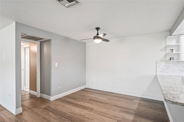9622 Brassie Ct Unit 9, New Port Richey, FL 34655 - spare room featuring wood finished floors, ceiling fan, baseboards, and a textured ceiling