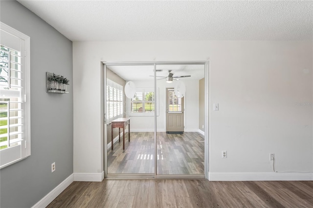 9622 Brassie Ct Unit 9, New Port Richey, FL 34655 - empty room with wood finished floors, a ceiling fan, baseboards, and a textured ceiling
